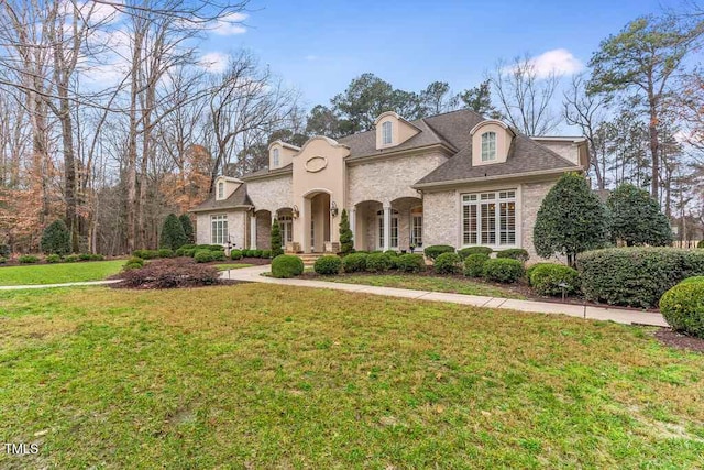 166 Bonica Creek Dr, Garner, NC 27529 - french country style house featuring a front lawn and brick siding