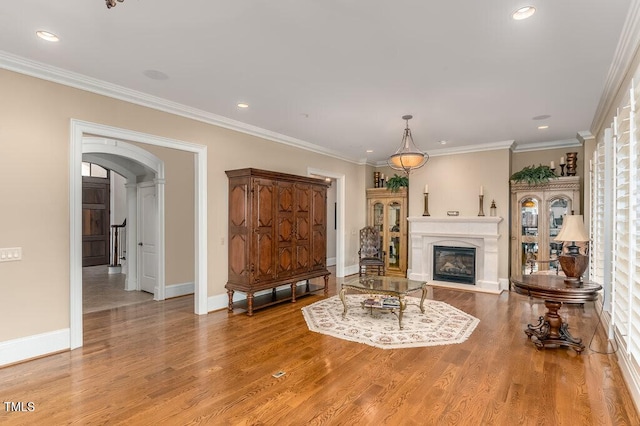 166 Bonica Creek Dr, Garner, NC 27529 - living area with arched walkways, light wood-style floors, recessed lighting, baseboards, and ornamental molding