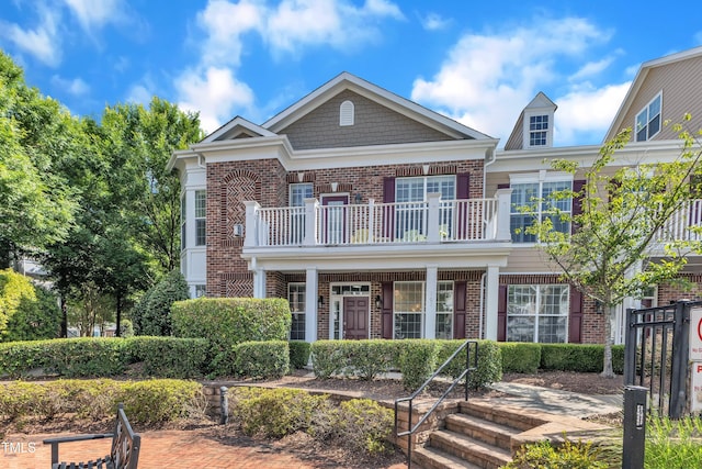 10511 Sablewood Dr Unit 107, Raleigh, NC 27617 - view of front of house featuring a balcony, brick siding, and covered porch