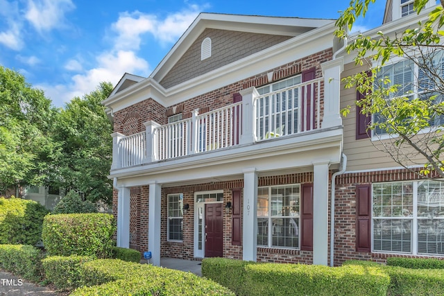 10511 Sablewood Dr Unit 107, Raleigh, NC 27617 - view of front facade with brick siding, a balcony, and a porch