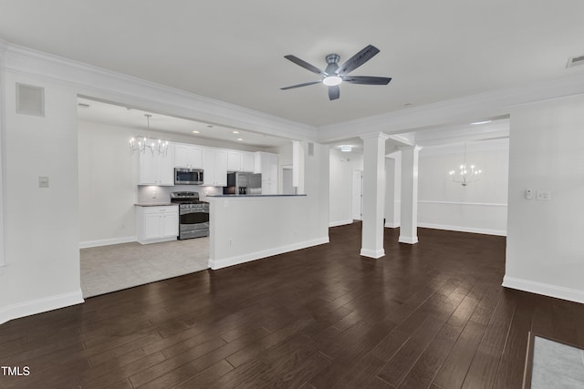 10511 Sablewood Dr Unit 107, Raleigh, NC 27617 - unfurnished living room featuring a chandelier, ceiling fan, wood finished floors, and ornamental molding