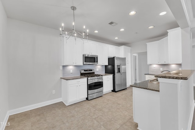 10511 Sablewood Dr Unit 107, Raleigh, NC 27617 - kitchen featuring stainless steel appliances, decorative backsplash, dark stone countertops, recessed lighting, and a chandelier