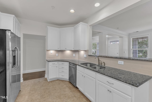 10511 Sablewood Dr Unit 107, Raleigh, NC 27617 - kitchen with stainless steel appliances, dark stone countertops, white cabinetry, tasteful backsplash, and recessed lighting