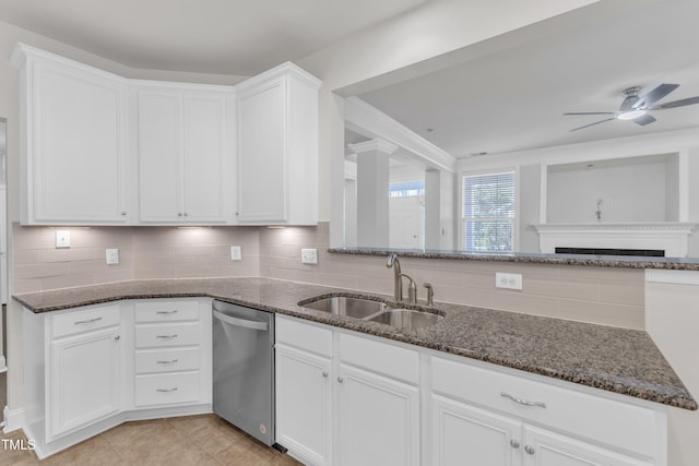 10511 Sablewood Dr Unit 107, Raleigh, NC 27617 - kitchen featuring dishwasher, dark stone counters, tasteful backsplash, a ceiling fan, and white cabinetry