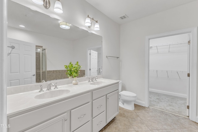 10511 Sablewood Dr Unit 107, Raleigh, NC 27617 - bathroom featuring double vanity, a stall shower, a spacious closet, and tile patterned flooring