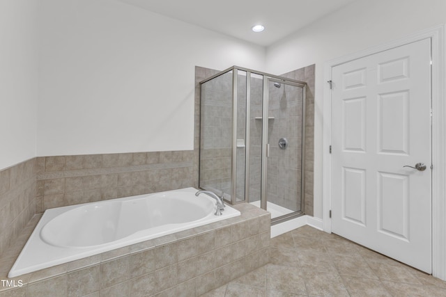 10511 Sablewood Dr Unit 107, Raleigh, NC 27617 - full bath featuring a garden tub, a shower stall, and tile patterned floors