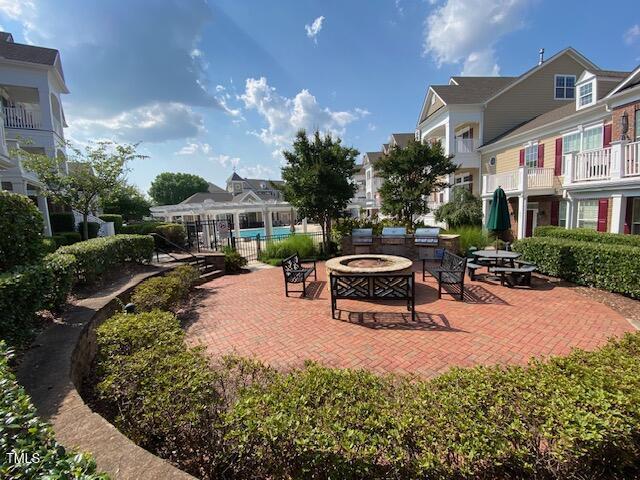 10511 Sablewood Dr Unit 107, Raleigh, NC 27617 - view of patio / terrace with a fire pit and a residential view