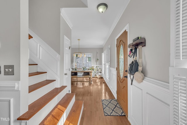 1905 Indianwood Ct, Raleigh, NC 27604 - entrance foyer featuring ornamental molding, stairway, wood finished floors, a decorative wall, and wainscoting