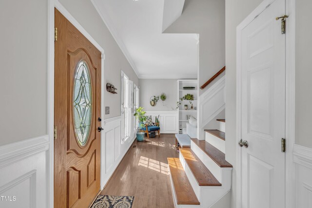1905 Indianwood Ct, Raleigh, NC 27604 - foyer entrance featuring crown molding, wainscoting, wood finished floors, and a decorative wall