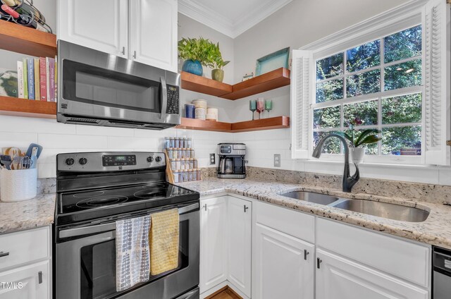 1905 Indianwood Ct, Raleigh, NC 27604 - kitchen featuring stainless steel appliances, open shelves, crown molding, a sink, and white cabinets