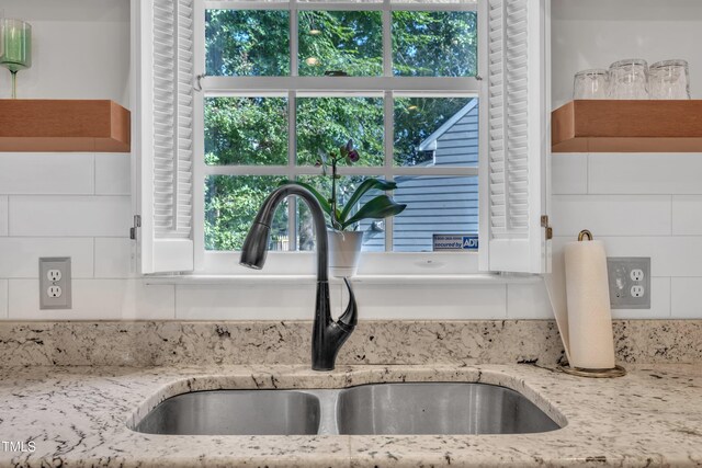 1905 Indianwood Ct, Raleigh, NC 27604 - kitchen view of a sink, backsplash, light stone countertops, and open shelves
