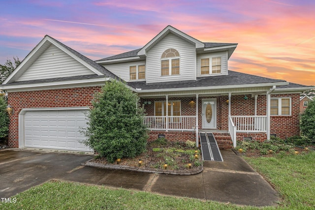 110 Windyfield Dr, Goldsboro, NC 27530 - view of front of house with brick siding, a porch, asphalt driveway, and a shingled roof