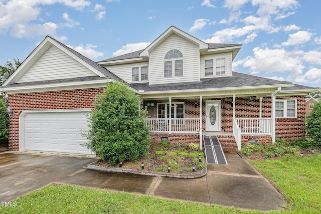 110 Windyfield Dr, Goldsboro, NC 27530 - view of front of house with covered porch, brick siding, concrete driveway, and a shingled roof