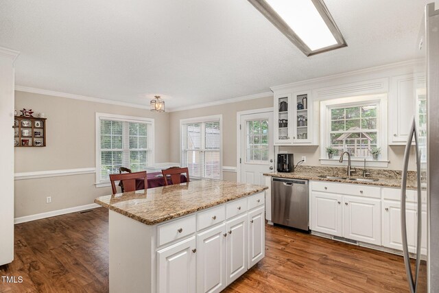 110 Windyfield Dr, Goldsboro, NC 27530 - kitchen featuring dishwasher, ornamental molding, a center island, dark wood-style flooring, and white cabinetry