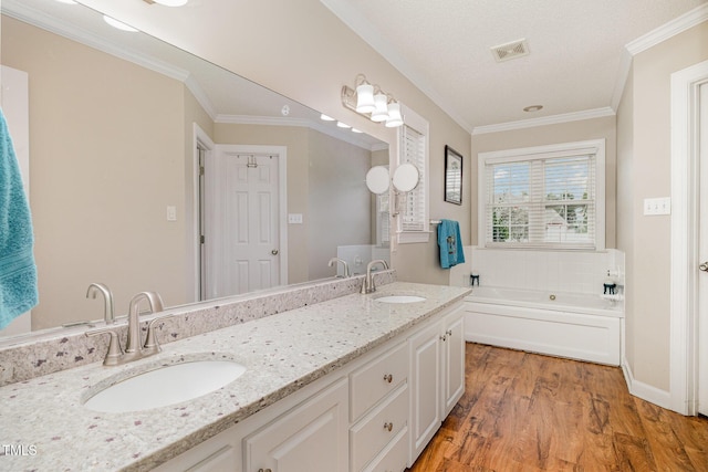110 Windyfield Dr, Goldsboro, NC 27530 - full bathroom with double vanity, wood finished floors, a garden tub, and crown molding