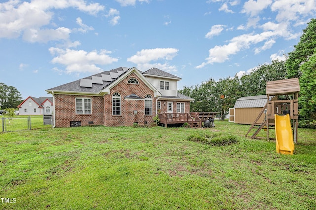 110 Windyfield Dr, Goldsboro, NC 27530 - rear view of property featuring brick siding, a storage unit, a wooden deck, a fenced backyard, and a playground
