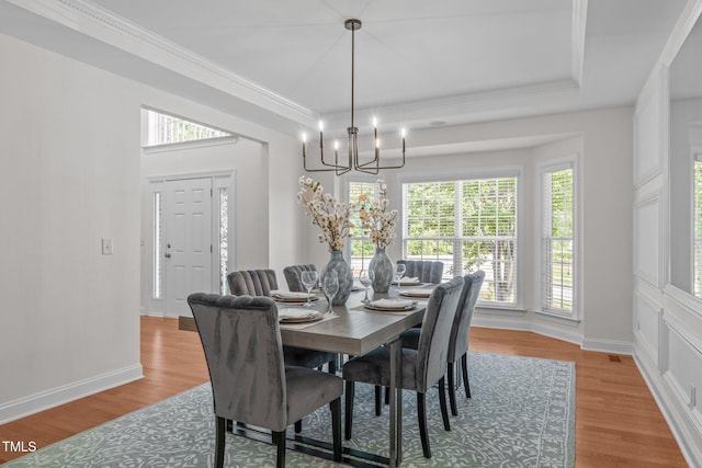 101 Quarryrock Rd, Holly Springs, NC 27540 - dining room featuring plenty of natural light, a chandelier, crown molding, and light wood-type flooring