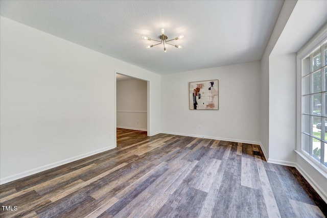 1209 Lochcarron Ln, Cary, NC 27511 - unfurnished room featuring a chandelier, dark wood finished floors, and baseboards