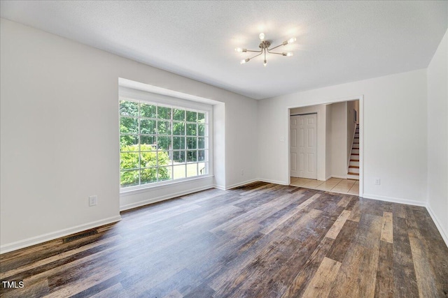 1209 Lochcarron Ln, Cary, NC 27511 - unfurnished bedroom with a chandelier, wood finished floors, and baseboards