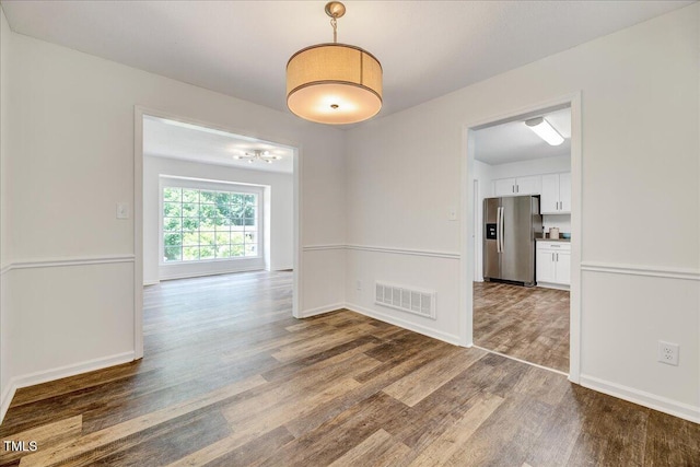 1209 Lochcarron Ln, Cary, NC 27511 - spare room featuring wood finished floors, a chandelier, and baseboards