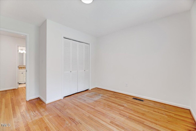 1209 Lochcarron Ln, Cary, NC 27511 - unfurnished bedroom with light wood-style flooring, baseboards, and a closet