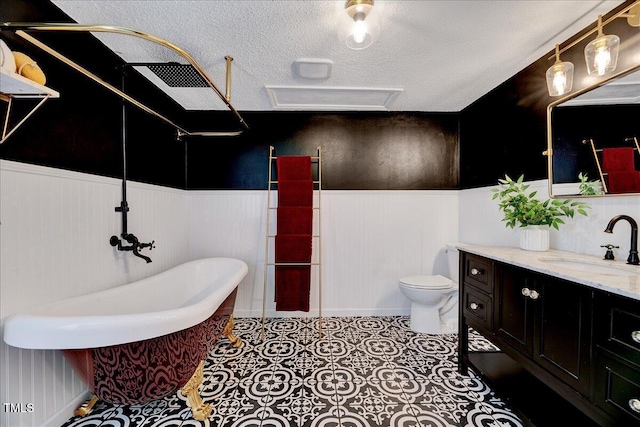1209 Lochcarron Ln, Cary, NC 27511 - full bathroom with a wainscoted wall, a freestanding bath, vanity, toilet, and a shower