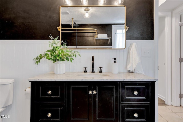 1209 Lochcarron Ln, Cary, NC 27511 - bathroom with vanity, wainscoting, tile patterned floors, and toilet
