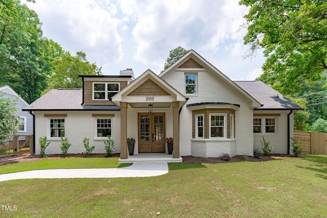 2100 Summit St, Durham, NC 27707 - view of front of property featuring french doors, brick siding, a chimney, and a shingled roof