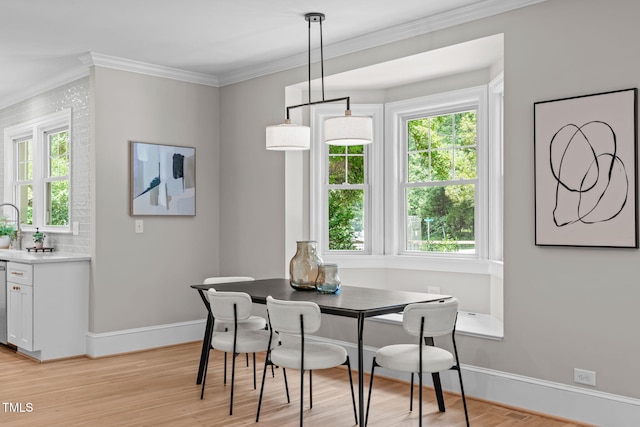 2100 Summit St, Durham, NC 27707 - dining area featuring ornamental molding, healthy amount of natural light, baseboards, and light wood-style floors