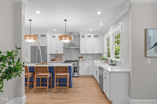 2100 Summit St, Durham, NC 27707 - kitchen featuring appliances with stainless steel finishes, wall chimney range hood, a sink, backsplash, and a breakfast bar