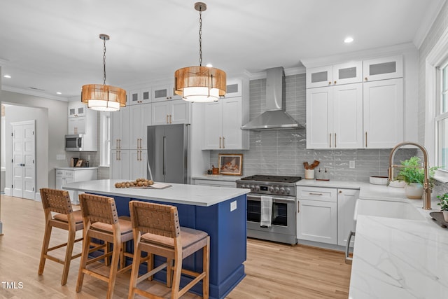2100 Summit St, Durham, NC 27707 - kitchen with high quality appliances, wall chimney exhaust hood, crown molding, decorative backsplash, and a center island
