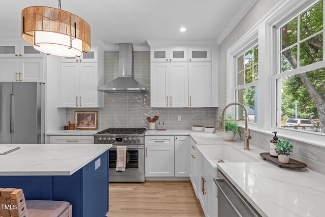 2100 Summit St, Durham, NC 27707 - kitchen featuring wall chimney exhaust hood, stainless steel appliances, a sink, white cabinets, and tasteful backsplash