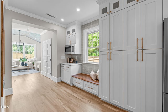 2100 Summit St, Durham, NC 27707 - kitchen with crown molding, light wood-type flooring, decorative backsplash, recessed lighting, and baseboards