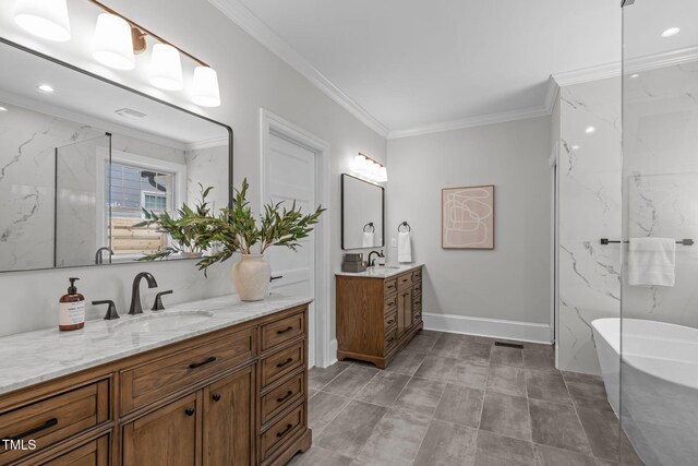 2100 Summit St, Durham, NC 27707 - bathroom with two vanities, a freestanding bath, crown molding, and recessed lighting