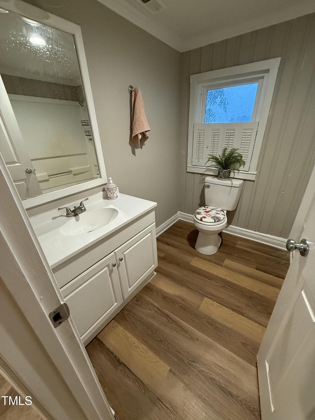 340 Jones Rd, Newton Grove, NC 28366 - half bath with toilet, vanity, wood finished floors, baseboards, and ornamental molding