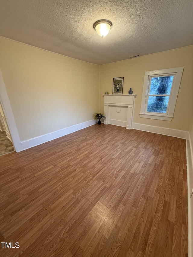 340 Jones Rd, Newton Grove, NC 28366 - spare room featuring wood finished floors, a textured ceiling, and baseboards