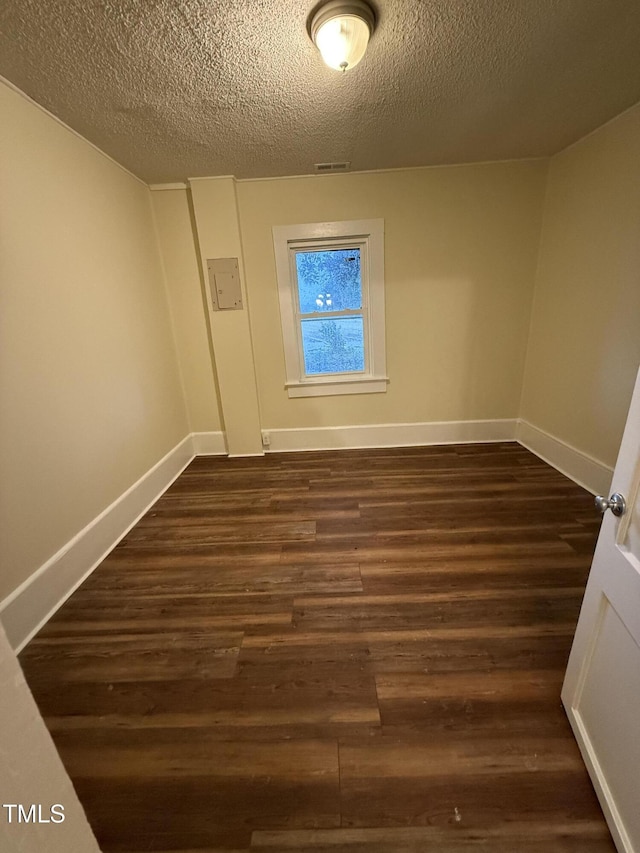 340 Jones Rd, Newton Grove, NC 28366 - spare room featuring dark wood finished floors, a textured ceiling, and baseboards