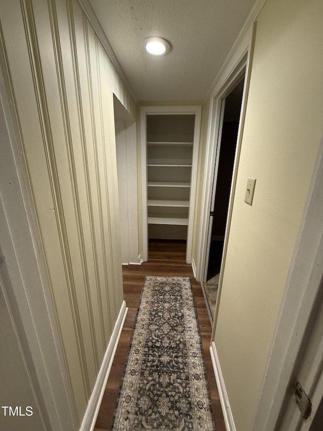 340 Jones Rd, Newton Grove, NC 28366 - hallway featuring dark wood-type flooring, a textured ceiling, baseboards, and built in features