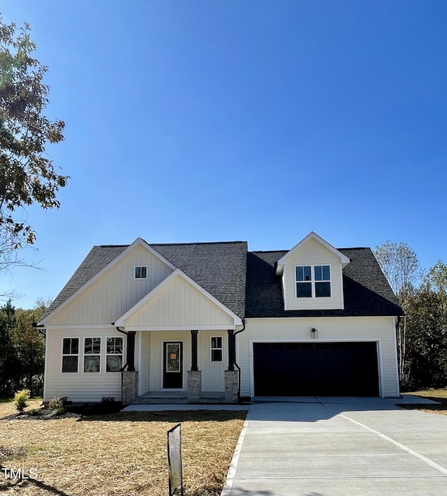 6786 Fire Tower Rd, Bailey, NC 27807 - modern farmhouse style home with covered porch, concrete driveway, a garage, and a shingled roof