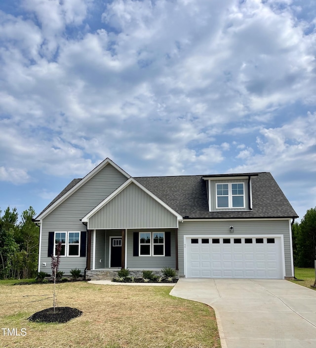 6786 Fire Tower Rd, Bailey, NC 27807 - view of front of property featuring concrete driveway, a garage, a front yard, and roof with shingles