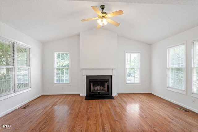 205 Mint Hill Dr, Cary, NC 27519 - unfurnished living room with a fireplace with flush hearth, wood finished floors, lofted ceiling, and a ceiling fan