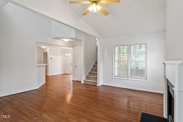 205 Mint Hill Dr, Cary, NC 27519 - unfurnished living room featuring stairway, ceiling fan, wood finished floors, a fireplace, and high vaulted ceiling
