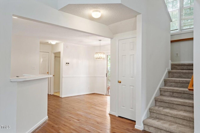 205 Mint Hill Dr, Cary, NC 27519 - stairway with wood finished floors and a chandelier