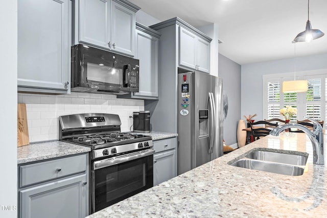 1448 Big Falls Dr, Wendell, NC 27591 - kitchen featuring stainless steel appliances, a sink, gray cabinets, backsplash, and decorative light fixtures