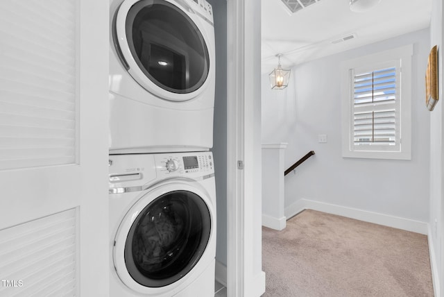 1448 Big Falls Dr, Wendell, NC 27591 - laundry area featuring estacked washer and dryer, carpet floors, and baseboards