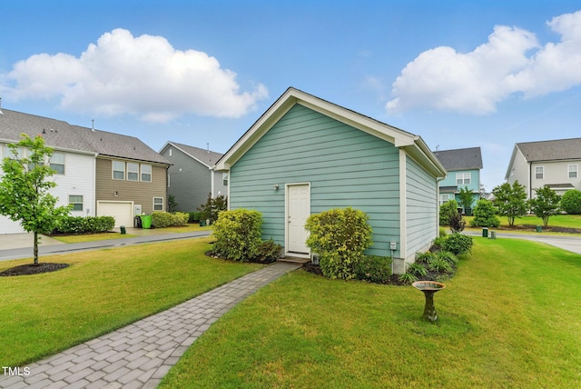 1448 Big Falls Dr, Wendell, NC 27591 - view of outbuilding with an attached garage, a residential view, and driveway