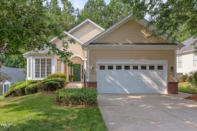 2026 Heritage Pines Dr, Cary, NC 27519 - view of front of home with concrete driveway, a garage, a front yard, and brick siding