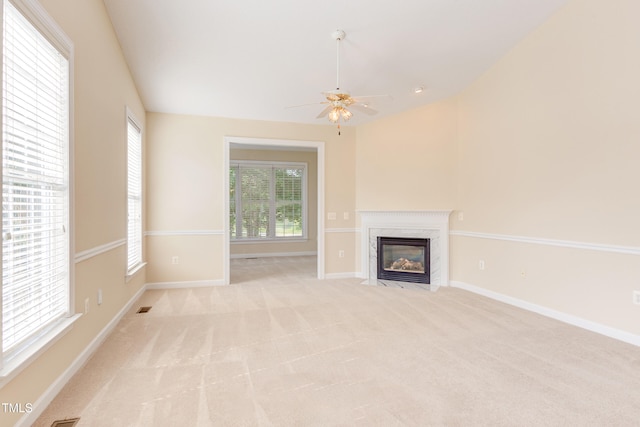 2026 Heritage Pines Dr, Cary, NC 27519 - unfurnished living room with a high end fireplace, light colored carpet, and ceiling fan