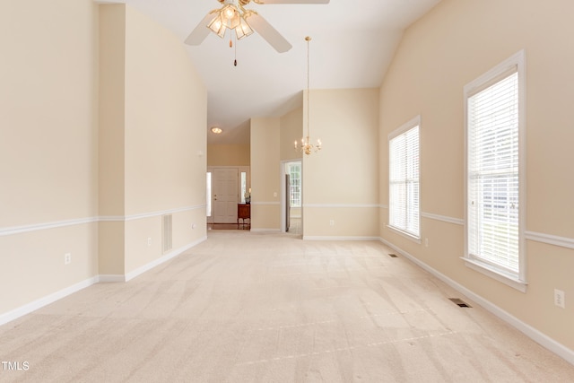 2026 Heritage Pines Dr, Cary, NC 27519 - unfurnished living room with ceiling fan, carpet floors, a chandelier, and high vaulted ceiling