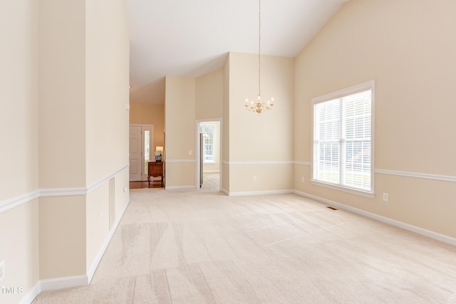2026 Heritage Pines Dr, Cary, NC 27519 - spare room featuring high vaulted ceiling, a chandelier, and light colored carpet